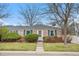 Charming brick ranch home with blue shutters and landscaped front yard at 6330 E 13Th Ave, Denver, CO 80220