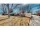 Charming brick home with blue shutters, mature trees, and a well-maintained lawn at 6330 E 13Th Ave, Denver, CO 80220