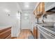 Functional kitchen with light wood cabinets, white appliances, and hardwood flooring at 6330 E 13Th Ave, Denver, CO 80220