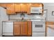 Efficient kitchen showcasing well-maintained appliances and wooden cabinetry, blending style with functionality at 6330 E 13Th Ave, Denver, CO 80220