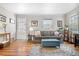 Inviting living room with hardwood floors, decor, and ample natural light streaming through large windows at 6330 E 13Th Ave, Denver, CO 80220