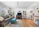 Bright living room with hardwood floors, sofa, ottoman, and decor at 6330 E 13Th Ave, Denver, CO 80220