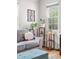 Cozy living room showing plants and shelves by a sunlit window and comfortable seating at 6330 E 13Th Ave, Denver, CO 80220