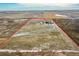 Aerial view of the property and surrounding area, with the red outline of the property lines at 48155 E 56Th Ave, Bennett, CO 80102