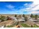 Backyard view shows open acreage, small trees, a garden and shed on a sunny day at 48155 E 56Th Ave, Bennett, CO 80102