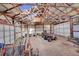 Large barn interior with high ceilings, open space, and garage doors with ATVs parked inside at 48155 E 56Th Ave, Bennett, CO 80102
