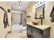 A well-appointed bathroom with a granite countertop, vessel sink, and tiled shower at 48155 E 56Th Ave, Bennett, CO 80102