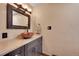 Charming powder room with a vessel sink, granite counters, and custom vanity at 48155 E 56Th Ave, Bennett, CO 80102