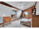 Tranquil bedroom with natural light, wood beam, and cozy sitting area at 48155 E 56Th Ave, Bennett, CO 80102
