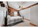 A rustic-style attic bedroom with a metal bed, hat rack, and wooden walls at 48155 E 56Th Ave, Bennett, CO 80102