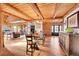Stunning dining room with exposed beams, wood floors, and ample space for entertaining at 48155 E 56Th Ave, Bennett, CO 80102
