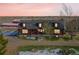 Exterior view of the home including a large red barn in the background at 48155 E 56Th Ave, Bennett, CO 80102