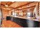 Bright, open kitchen with granite countertops, dark cabinets, and stainless steel appliances at 48155 E 56Th Ave, Bennett, CO 80102
