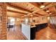 Open concept kitchen with island, wood beam ceilings, hardwood floors and modern appliances at 48155 E 56Th Ave, Bennett, CO 80102