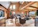 Bright living room with a cozy fireplace, wood floors, and ample natural light at 48155 E 56Th Ave, Bennett, CO 80102