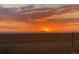 View of sunset over the property showing colorful sky, open fields, and silhouette of distant mountains at 48155 E 56Th Ave, Bennett, CO 80102