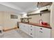 Finished basement features wet bar, shelving, sink, mini fridge, and white cabinets at 48155 E 56Th Ave, Bennett, CO 80102