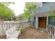Backyard view of a tool shed with a white decorative bench and small table near the house at 3186 Springmeadow Cir, Castle Rock, CO 80109
