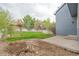 A backyard offering a pergola, green lawn, rock landscaping, a fenced perimeter and access to the house at 3186 Springmeadow Cir, Castle Rock, CO 80109