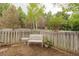 Serene backyard showcasing a decorative bench and a small table, all enclosed by a white wooden fence at 3186 Springmeadow Cir, Castle Rock, CO 80109