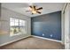A bedroom showcasing blue accent wall, ceiling fan, carpeted floors, natural light and a view to the outside at 3186 Springmeadow Cir, Castle Rock, CO 80109