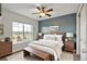 Bedroom with a queen bed, a bench, two side tables, two lamps, carpeted floor and a ceiling fan at 3186 Springmeadow Cir, Castle Rock, CO 80109