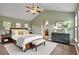 Bedroom features a queen bed, vaulted ceiling, ceiling fan, and an ensuite bathroom through an archway at 3186 Springmeadow Cir, Castle Rock, CO 80109