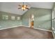 Spacious carpeted bedroom offering ample natural light, vaulted ceiling, ceiling fan, and an archway leading to the bath at 3186 Springmeadow Cir, Castle Rock, CO 80109