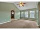A spacious bedroom with vaulted ceiling, an archway to a shower, and multiple windows illuminating carpeted floors at 3186 Springmeadow Cir, Castle Rock, CO 80109