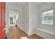 Bright entryway featuring hardwood floors, an arched doorway, and a built-in bench by a window at 3186 Springmeadow Cir, Castle Rock, CO 80109