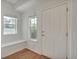 Light-filled entryway with hardwood floors, white trim, and a convenient built-in bench under the windows at 3186 Springmeadow Cir, Castle Rock, CO 80109