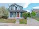 Charming blue two-story home with a welcoming red door, white porch columns, and a well-manicured lawn at 3186 Springmeadow Cir, Castle Rock, CO 80109