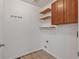 Functional laundry room with overhead cabinets and open shelving, ready for your appliances at 3186 Springmeadow Cir, Castle Rock, CO 80109