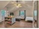 Lofted living room with dining table, sofa, full bed, ceiling fan and views of outside at 3186 Springmeadow Cir, Castle Rock, CO 80109