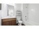 Well-lit bathroom with a single sink, bathtub, and shower, offering a practical and clean space for daily routines at 9756 Ash Ln, Thornton, CO 80229
