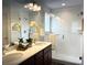 Stylish bathroom with a double vanity, glass-enclosed shower, and modern fixtures for a spa-like experience at 9756 Ash Ln, Thornton, CO 80229