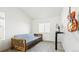 Bright bedroom featuring a futon, gray concrete floor, and ample natural light through the windows at 9756 Ash Ln, Thornton, CO 80229