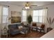 Inviting living room featuring stylish decor, hardwood floors, and an abundance of natural light from large windows at 9756 Ash Ln, Thornton, CO 80229
