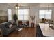Open-concept living space featuring a modern kitchen island and a comfortable living area with plenty of natural light at 9756 Ash Ln, Thornton, CO 80229