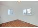 Well-lit bedroom with hardwood floors and two windows providing ample natural light at 1364 Lansing St, Aurora, CO 80010