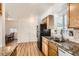 Functional kitchen featuring a stainless steel sink, granite countertops, and wooden cabinetry at 1364 Lansing St, Aurora, CO 80010