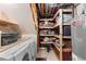 Basement laundry room with shelving and storage space for household supplies at 2231 E 128Th Ave, Thornton, CO 80241