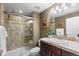 Bathroom with glass enclosed tiled shower, dark vanity, and updated fixtures at 2231 E 128Th Ave, Thornton, CO 80241