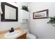 Well-maintained bathroom featuring traditional vanity, toilet, and a decorative shelf at 2231 E 128Th Ave, Thornton, CO 80241