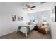 Bright bedroom with ceiling fan, large window, and cozy decor at 2231 E 128Th Ave, Thornton, CO 80241