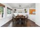 Bright dining room featuring hardwood floors, a chandelier, and two decorative shelves at 2231 E 128Th Ave, Thornton, CO 80241