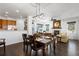Open-concept dining area with dark hardwood flooring and sightlines to the living room at 2231 E 128Th Ave, Thornton, CO 80241
