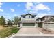 Inviting two-story home featuring a well-maintained lawn, two-car garage, and freshly painted exterior at 2231 E 128Th Ave, Thornton, CO 80241