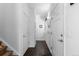 Well-lit hallway featuring hardwood floors, white doors, and neutral wall color at 2231 E 128Th Ave, Thornton, CO 80241