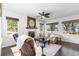 Inviting living area with fireplace, hardwood flooring, and plenty of natural light from the many windows at 2231 E 128Th Ave, Thornton, CO 80241